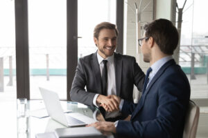 Two sales people shaking hands