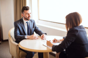 Sales candidate and sales recruiter discussing money